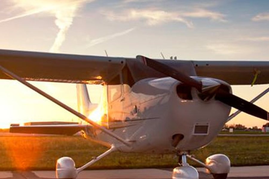 Small plane on a runway at sunset