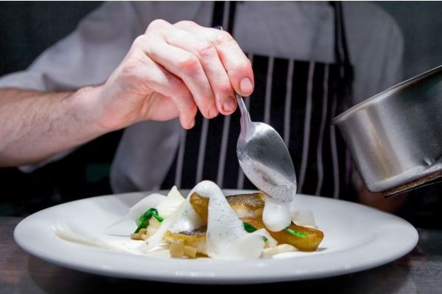 Chef plating a fine dining dish