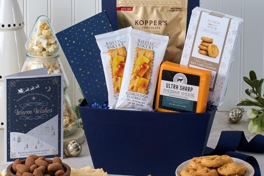 Winter holiday gift basket with crackers, cheese, cookies and chocolate