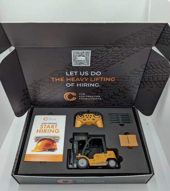 The Contractor Consultants kit: an open custom-printed box reading Let us do the heavy lifting of hiring, with a QR code, a foam insert holding a remote-control forklift, its controller and pallets, and a Stop Posting, Start Hiring guidebook