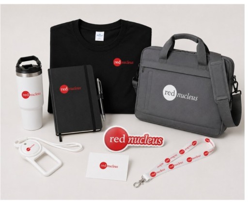 Red Nucleus Voyage Ready onboarding kit with messenger bag, tumbler, branded tee, journal, lanyard, and stickers