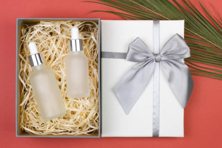 Cosmetic bottles with body oils or facial serum in a gift box. Clean cosmetic bottles for branding
