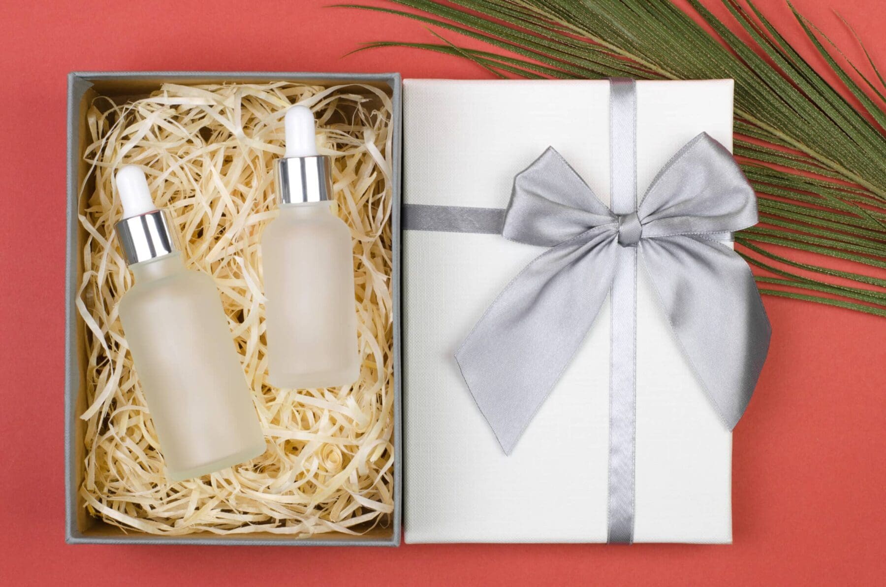 Cosmetic bottles with body oils or facial serum in a gift box. Clean cosmetic bottles for branding
